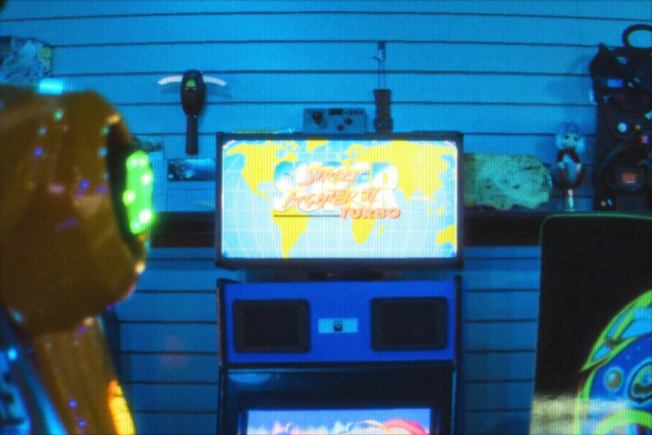 A Street Fighter II cabinet re-lit through a coin-op slot mask — Arcade